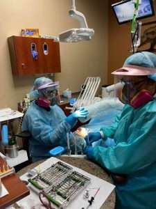 Dr. Teresa Scott and assistant with dental patient